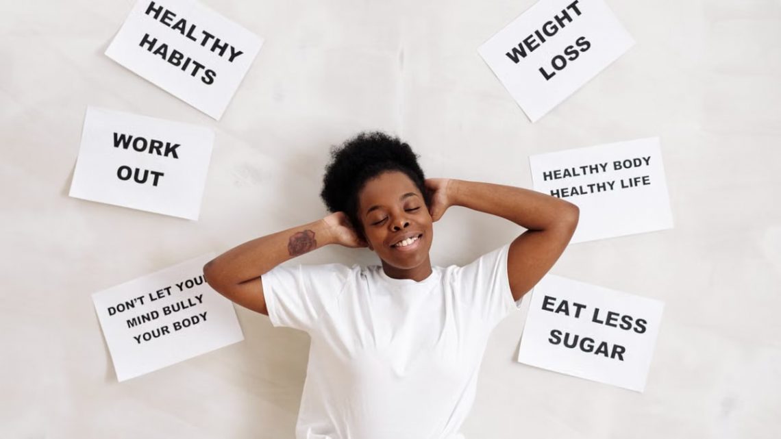 Smiling woman embracing positive lifestyle with healthy living messages around her.